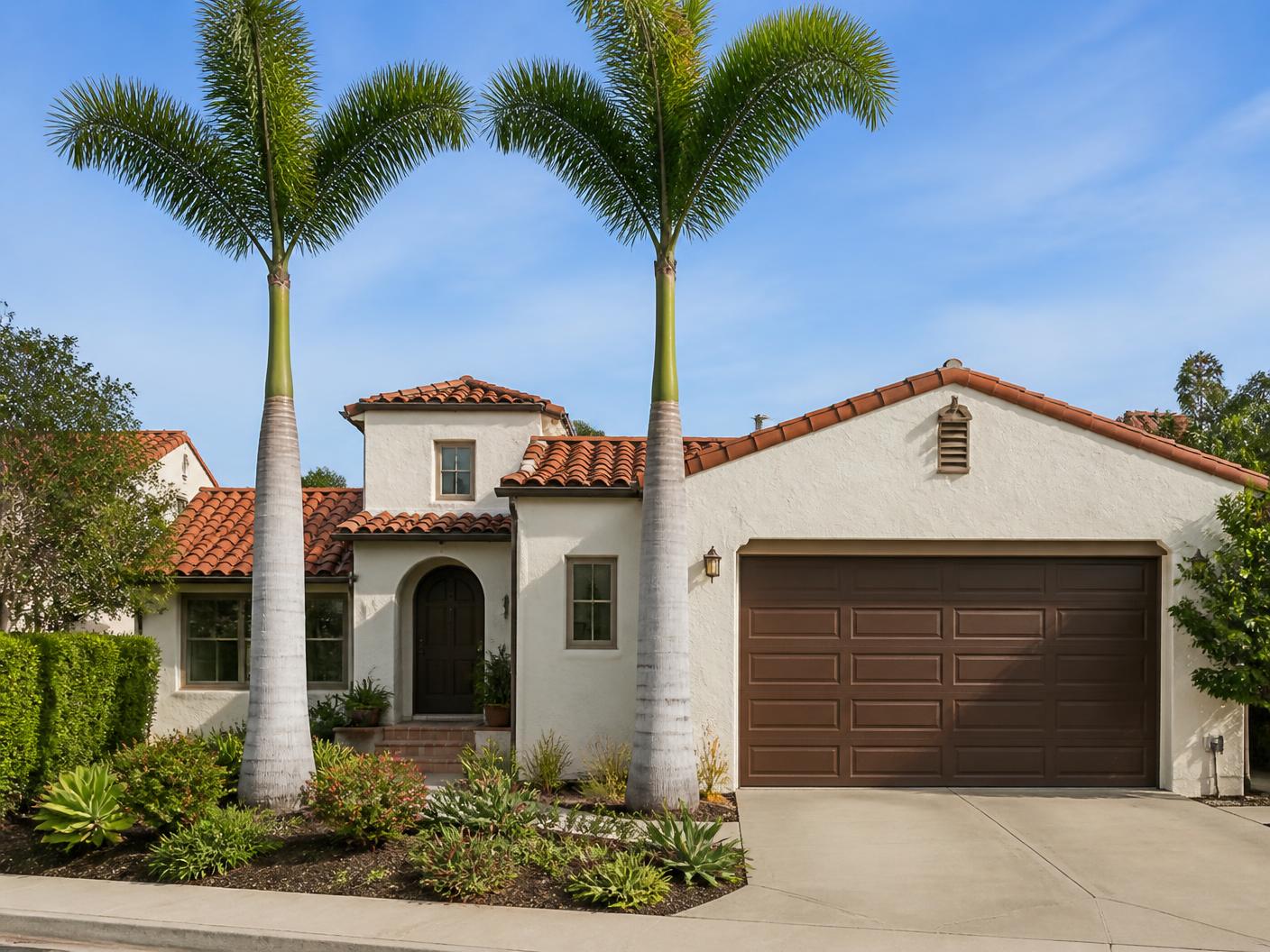 Queen palms trimmed and the driveway swept clean at a San Diego home